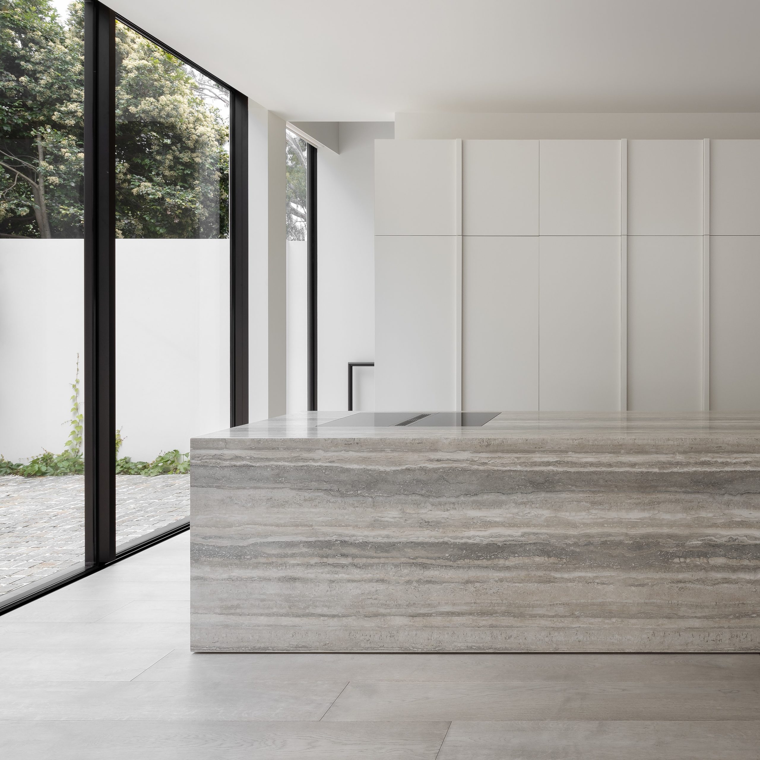 Beautiful minimalist kitchen featuring tactile grey Otto flooring in XI Pewter and a stone island bench