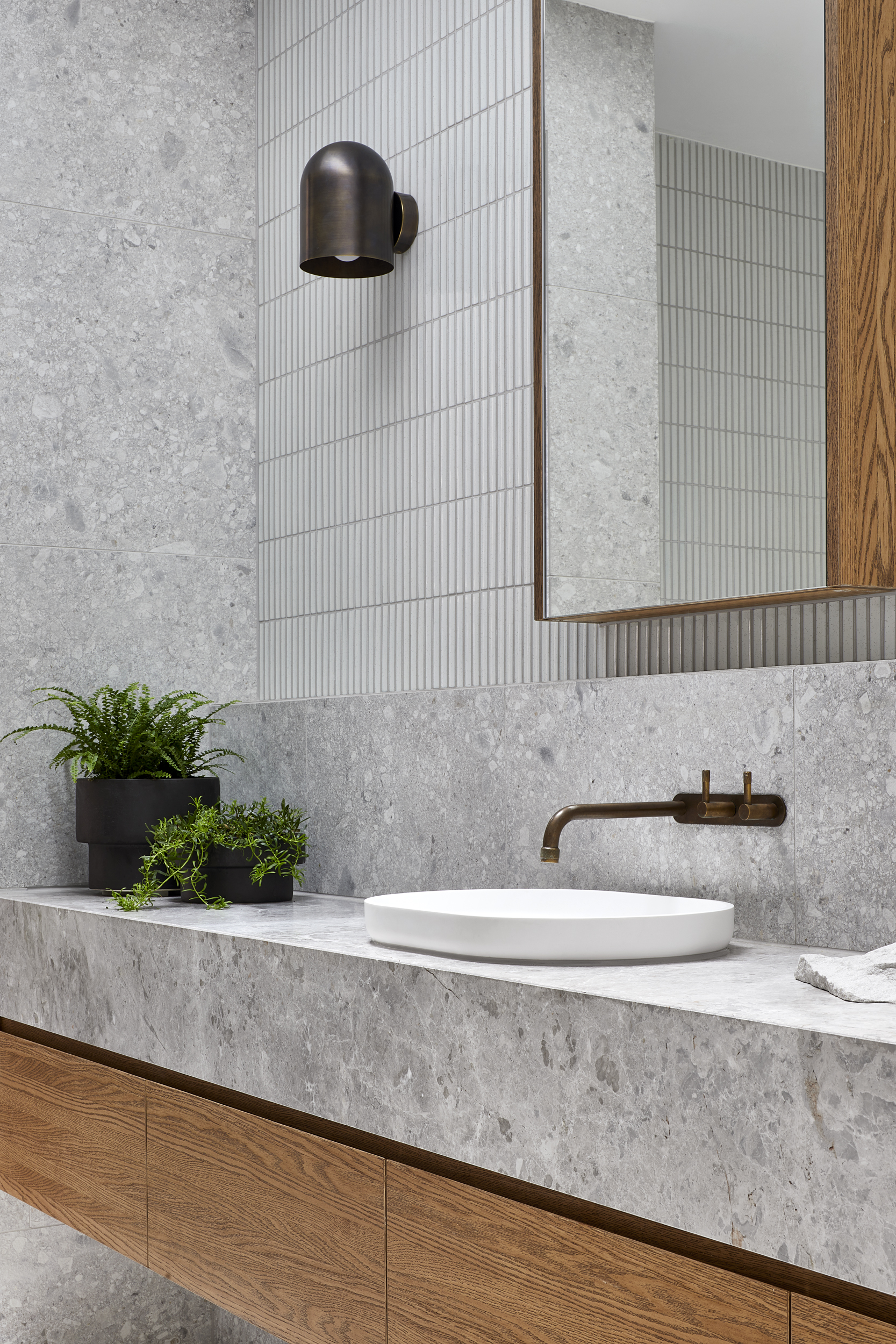 A stunning stone and timber bathroom featuring Lignapal pre-finished timber veneer joinery