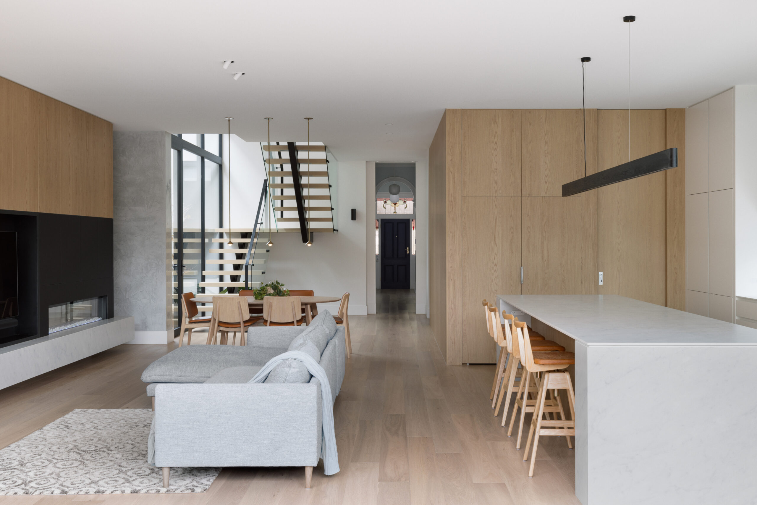 Modern open-plan living and dining area with oak effect laminate joinery, crafted from Cellupal Eik timber-look laminate from George Fethers & Co.